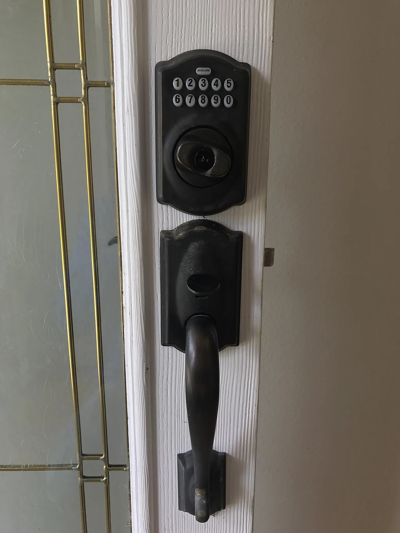 Keypad deadbolt and handle set installed on a front door