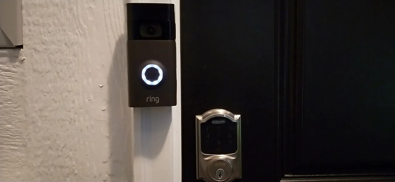 Ring video doorbell and smart lock installed by a front door